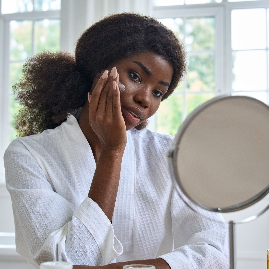 African American Woman massaging face
